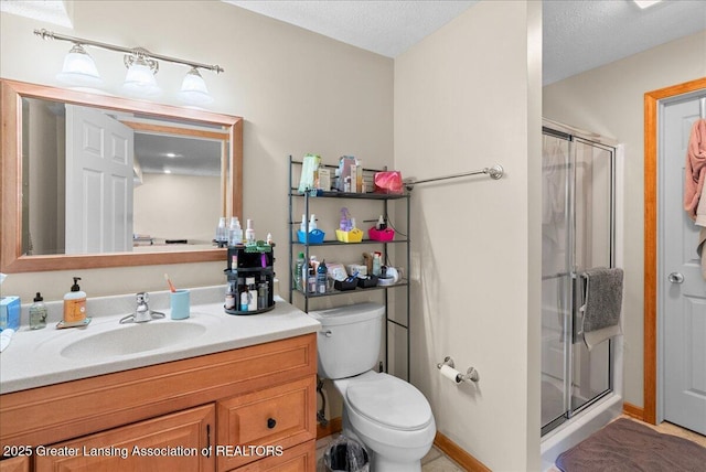full bath with toilet, a textured ceiling, a shower stall, and vanity
