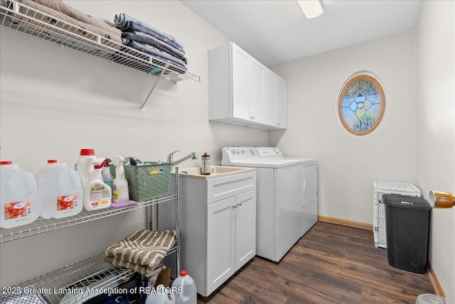 laundry area featuring baseboards, dark wood-type flooring, cabinet space, and washer and dryer