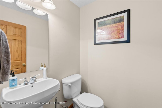 bathroom with toilet and a sink