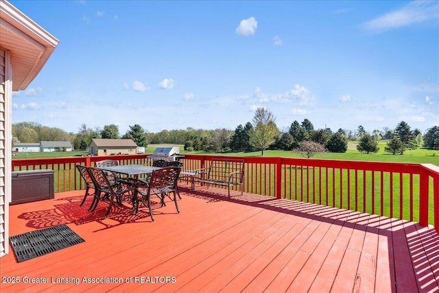 deck featuring a lawn, outdoor dining space, and area for grilling