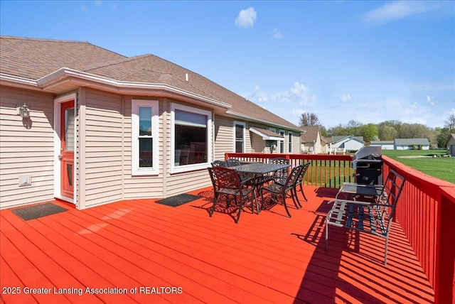 deck featuring a grill and outdoor dining space