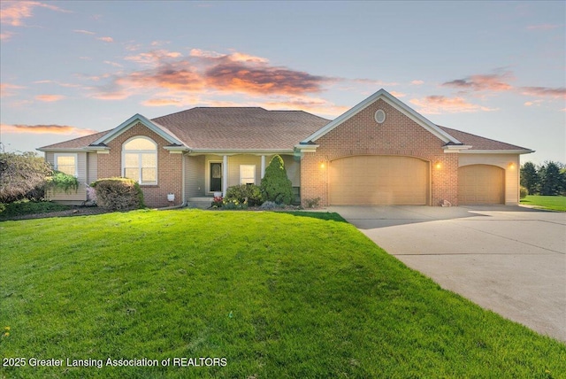 ranch-style home featuring a lawn, brick siding, an attached garage, driveway, and a porch