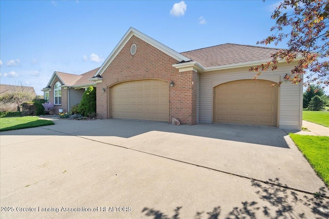 ranch-style house featuring concrete driveway, brick siding, and a garage