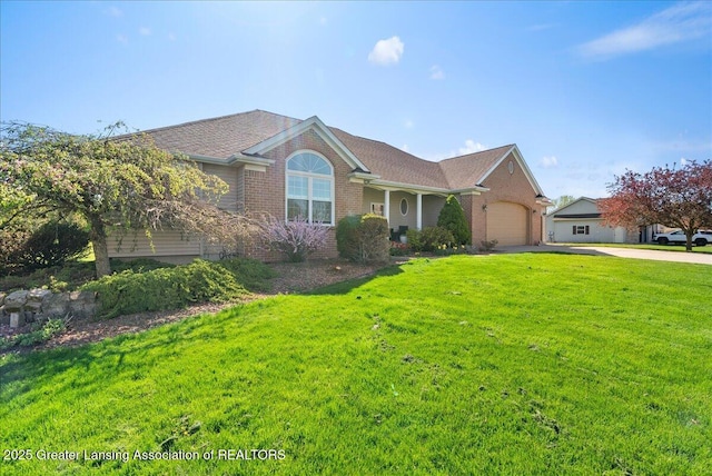 ranch-style house with brick siding, a garage, a front yard, and concrete driveway