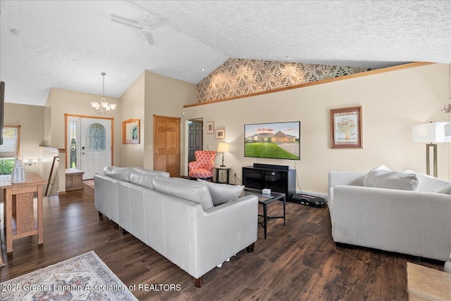 living area with a textured ceiling, high vaulted ceiling, an inviting chandelier, and dark wood finished floors