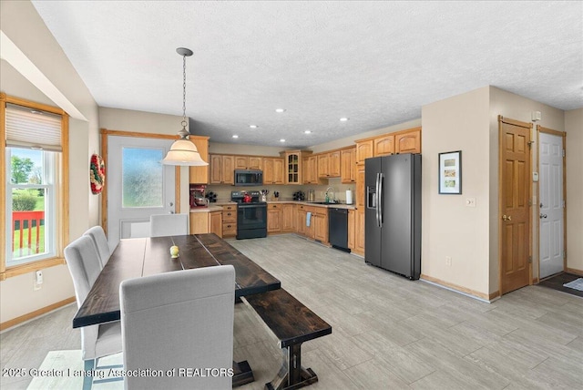 dining area featuring baseboards, recessed lighting, and a textured ceiling
