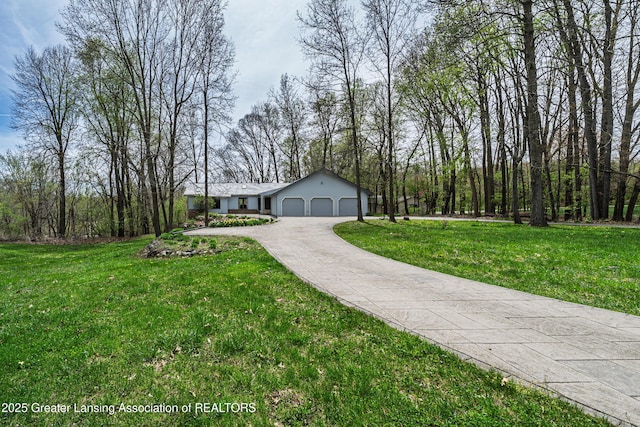 ranch-style house with driveway, a front lawn, and a garage