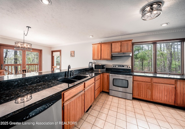 kitchen featuring plenty of natural light, a sink, light tile patterned floors, and stainless steel appliances