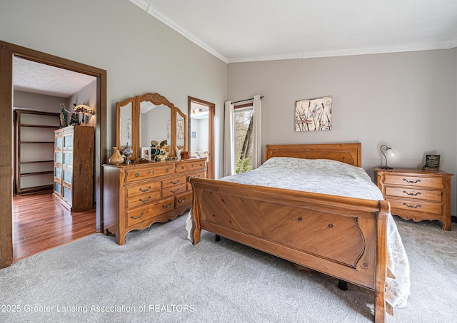 bedroom featuring crown molding and light colored carpet