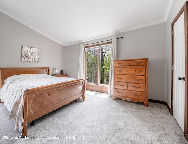 bedroom featuring baseboards, ornamental molding, light carpet, and vaulted ceiling
