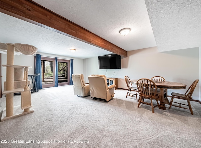 carpeted dining area with baseboards, beam ceiling, and a textured ceiling