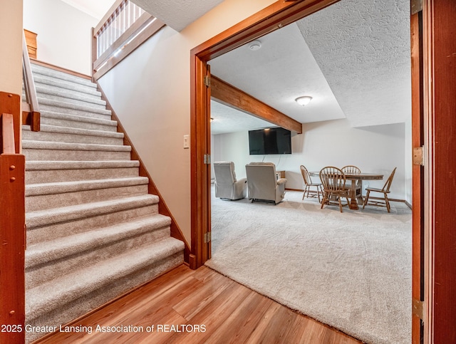 stairs with baseboards and wood finished floors