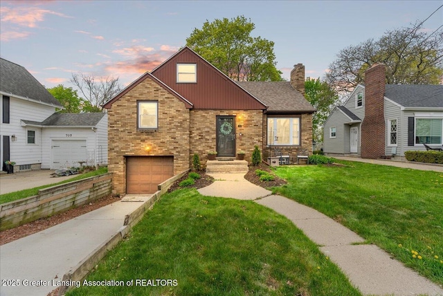 view of front facade with board and batten siding, a front yard, brick siding, concrete driveway, and an attached garage