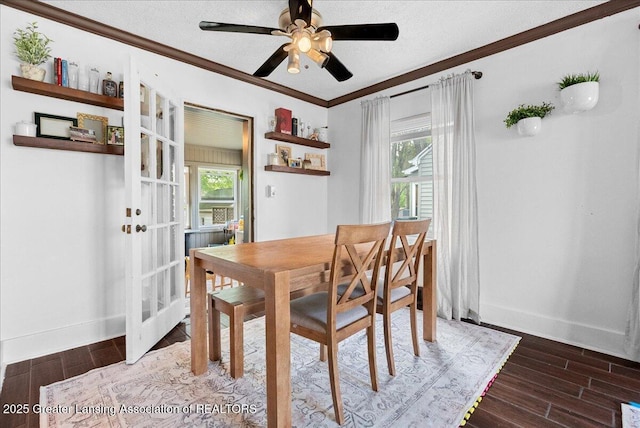 dining area with plenty of natural light, a ceiling fan, crown molding, and wood finished floors