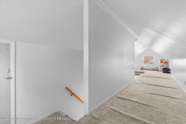 stairway with baseboards, carpet, and lofted ceiling
