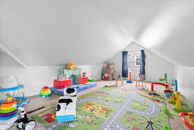 rec room featuring lofted ceiling and carpet