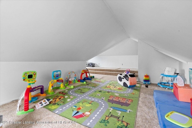 recreation room with carpet floors and vaulted ceiling