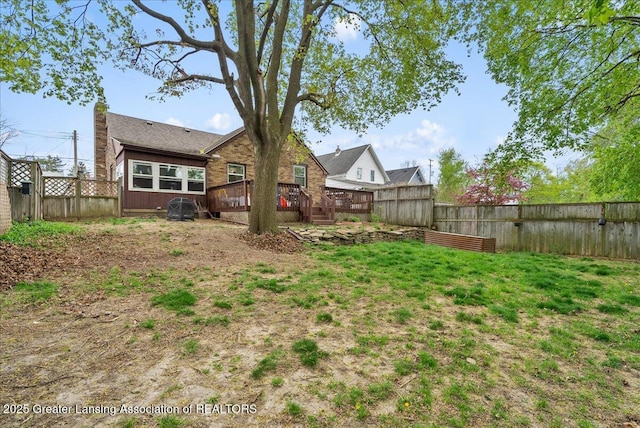 view of yard with a deck and a fenced backyard
