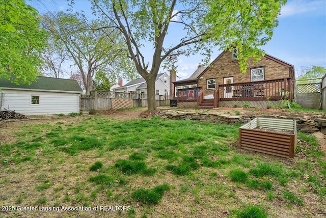 view of yard featuring fence and a wooden deck