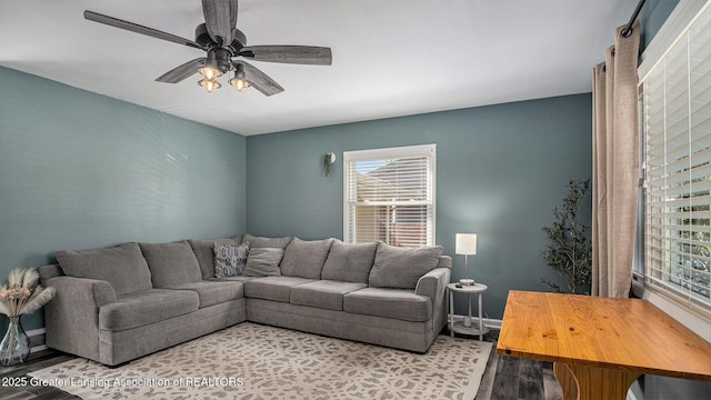 living room with baseboards, ceiling fan, plenty of natural light, and wood finished floors