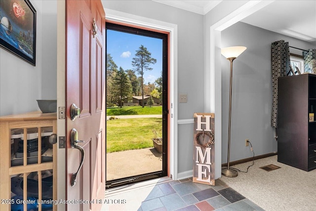 12188 Forest Meadow Dr, Perry, MI 48872 - foyer entrance with visible vents, ornamental molding, baseboards, and stone finish flooring