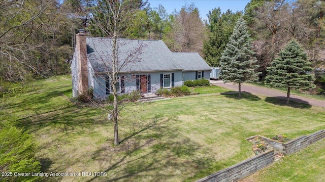 12188 Forest Meadow Dr, Perry, MI 48872 - ranch-style house featuring fence, a chimney, and a front yard