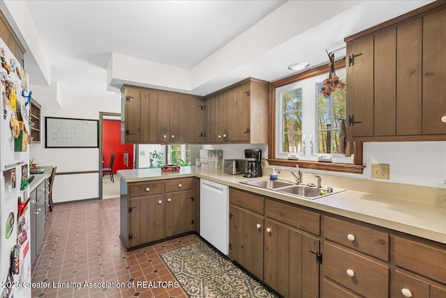 12188 Forest Meadow Dr, Perry, MI 48872 - kitchen with light countertops, a peninsula, a sink, and dishwasher