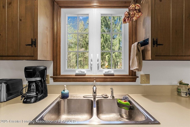 12188 Forest Meadow Dr, Perry, MI 48872 - kitchen with light countertops, dark brown cabinetry, and a sink