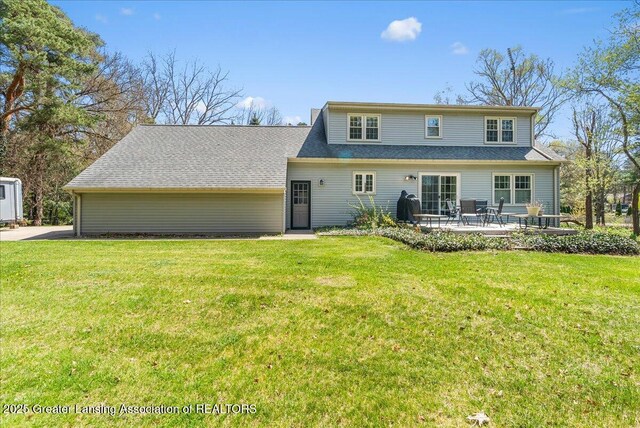 12188 Forest Meadow Dr, Perry, MI 48872 - back of property featuring a patio and a yard