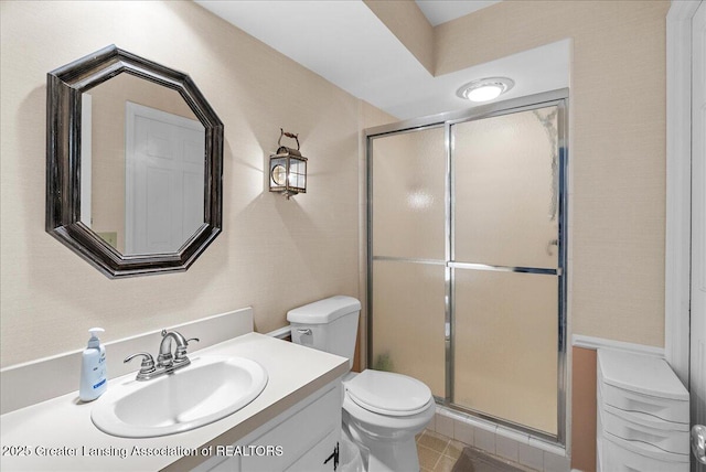 12188 Forest Meadow Dr, Perry, MI 48872 - full bathroom featuring vanity, tile patterned floors, a shower stall, and toilet