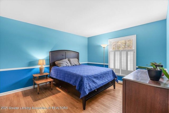 12188 Forest Meadow Dr, Perry, MI 48872 - bedroom featuring baseboards and hardwood / wood-style flooring