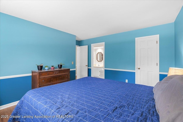 12188 Forest Meadow Dr, Perry, MI 48872 - bedroom featuring baseboards, wood finished floors, and ensuite bathroom