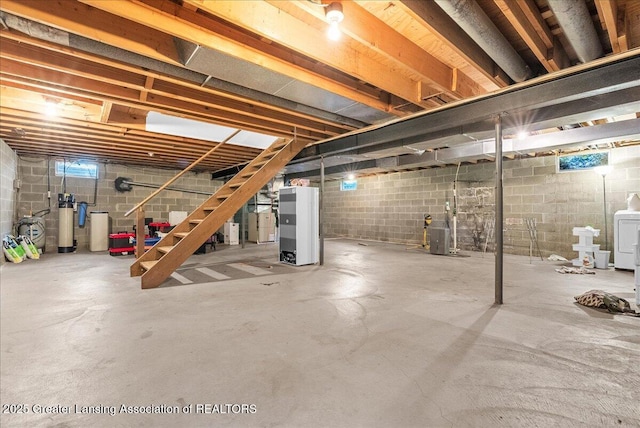 12188 Forest Meadow Dr, Perry, MI 48872 - below grade area featuring washer / dryer, heating unit, and stairway