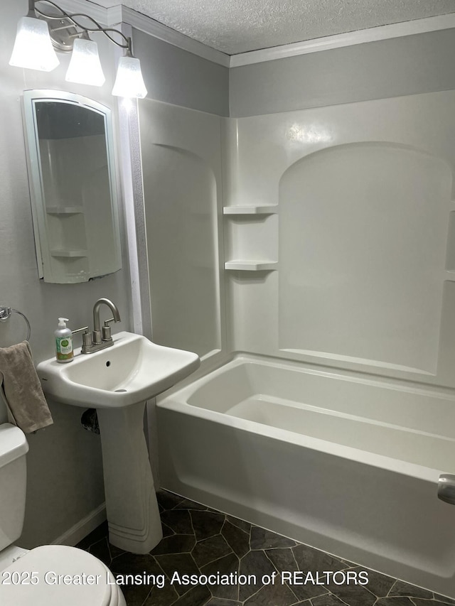 full bathroom with tile patterned flooring, a textured ceiling, toilet, and shower / washtub combination