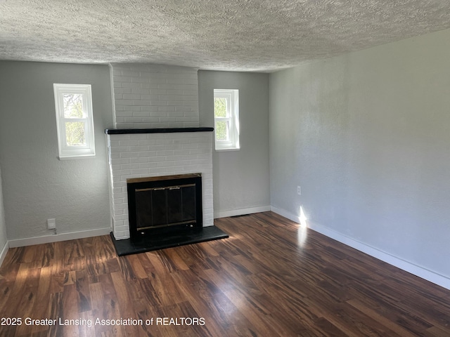 unfurnished living room featuring baseboards and a textured ceiling
