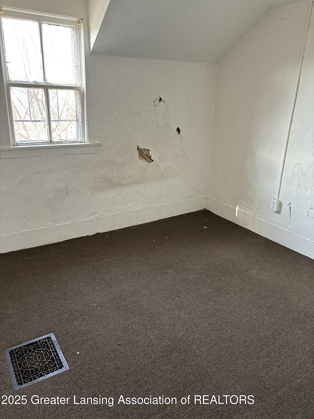 empty room with visible vents, carpet, and baseboards