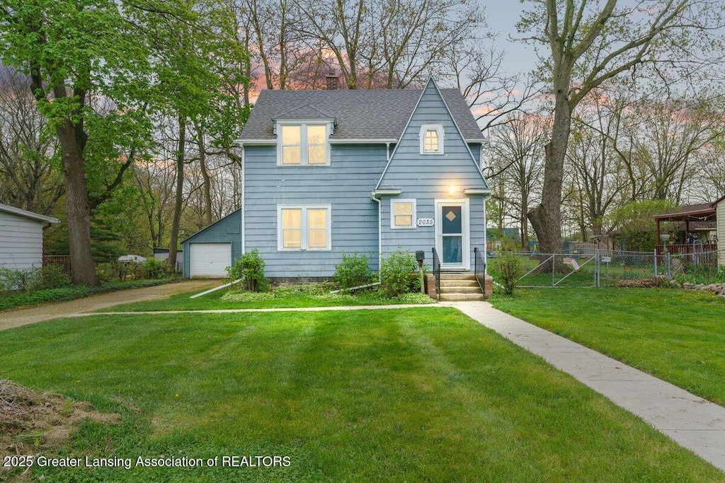 view of front of house featuring fence, a shingled roof, a garage, a front yard, and a chimney