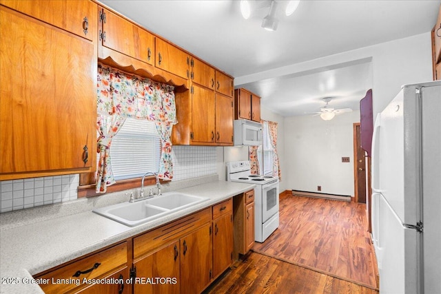 2035 Mary Ave, Lansing, MI 48910 - kitchen featuring ceiling fan, baseboard heating, a sink, light countertops, and white appliances
