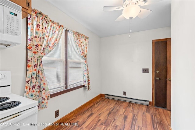 2035 Mary Ave, Lansing, MI 48910 - interior space featuring ceiling fan, wood finished floors, baseboards, a baseboard heating unit, and white appliances