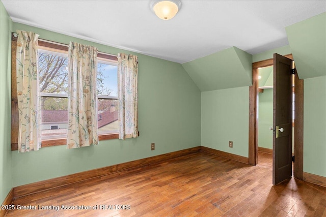 2035 Mary Ave, Lansing, MI 48910 - additional living space with baseboards, lofted ceiling, and wood finished floors