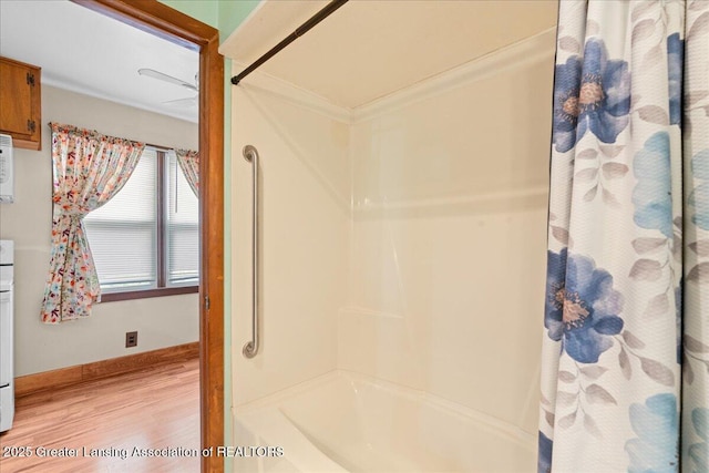 2035 Mary Ave, Lansing, MI 48910 - full bath featuring baseboards, wood finished floors, and shower / bath combo with shower curtain