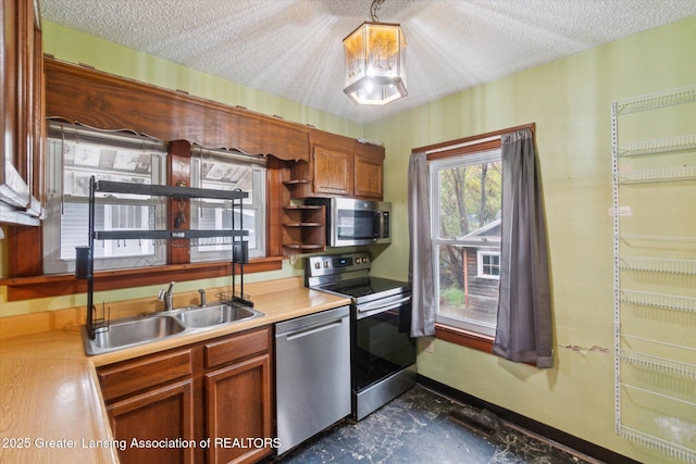 kitchen featuring light countertops, stainless steel appliances, open shelves, and a textured ceiling