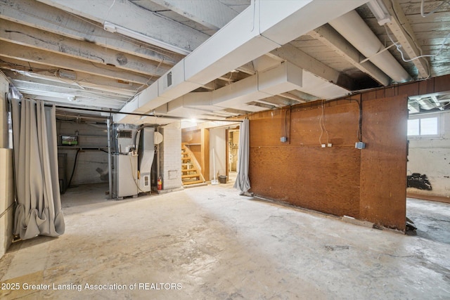 below grade area with heating unit and stairs