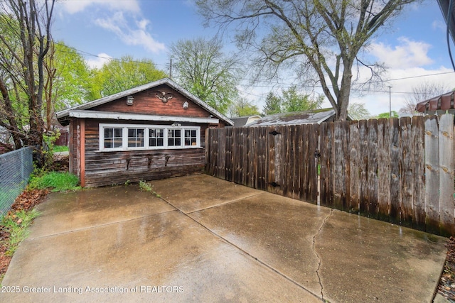back of house featuring a patio and a fenced backyard