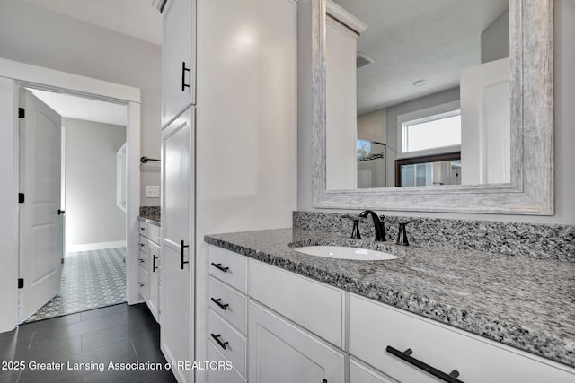 bathroom with vanity and baseboards