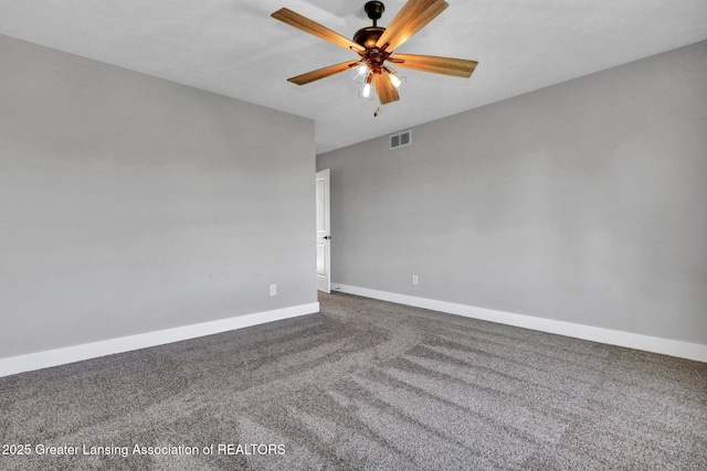 carpeted empty room featuring baseboards, a ceiling fan, and visible vents