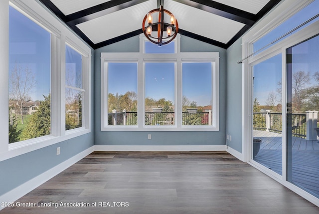 unfurnished sunroom featuring baseboards, vaulted ceiling with beams, wood finished floors, and a chandelier