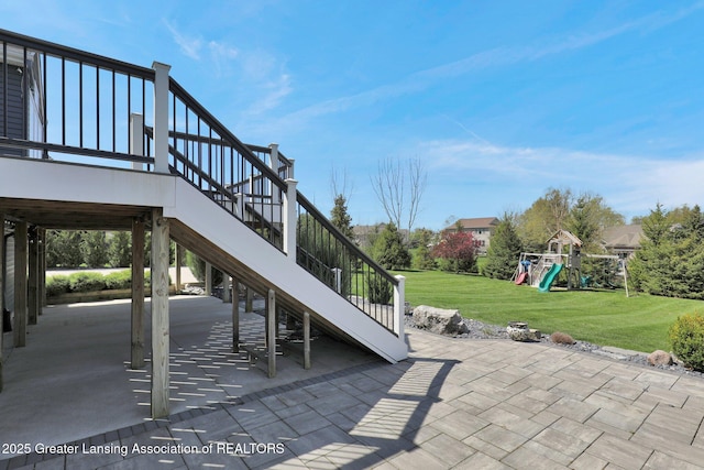 view of patio featuring stairway and a playground