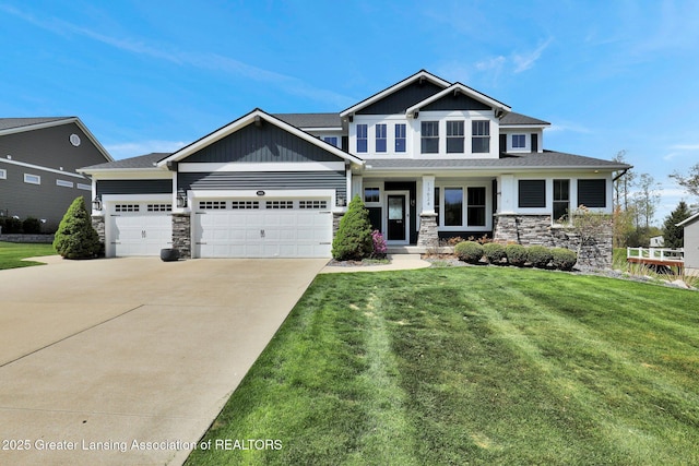 craftsman house featuring an attached garage, driveway, a front lawn, and stone siding