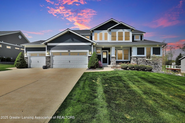 craftsman-style home featuring a lawn, an attached garage, concrete driveway, and stone siding